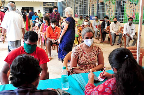 Beneficiaries register themselves to get a dose of COVID-19 vaccine at a vaccination centre, in Bengaluru on Monday. (Photo | ANI)