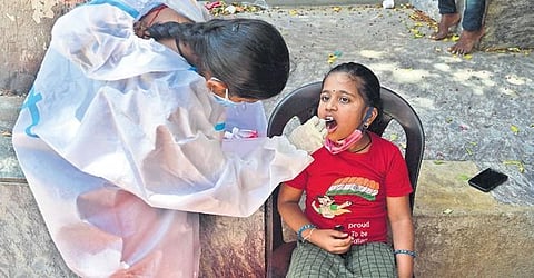 A health worker collects swab samples of a child in Bengaluru |ashishkrishna HP
