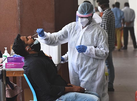 Swab samples been collected from the passengers who arrived at Chennai Airport International Airport. (Photo | Ashwin Prasath, EPS)