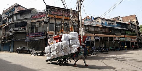 (Representational Image)A worker pulls handcart during the lockdown imposed amid the rise in COVID-19 cases in New Delhi. (Photo| ANI)