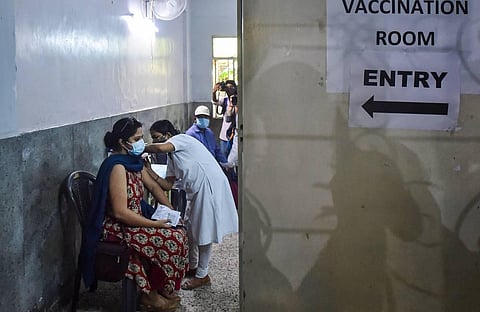 A health worker administers a dose of the COVID-19 vaccine to a woman, at a vaccination centre in Kolkata, Saturday, June 5, 2021. (Photo | PTI)