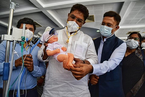 Minister R Ashok going through the ‘Bubble CPAP’  a non-invasive ventilation for newborns with infant respiratory distress syndrome (IRDS) displayed at the workshop in Bengaluru. (Photo | Shriram B N)