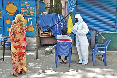 A health worker collects swab samples of a man in Bengaluru. (File Photo | Shriram BN, EPS)