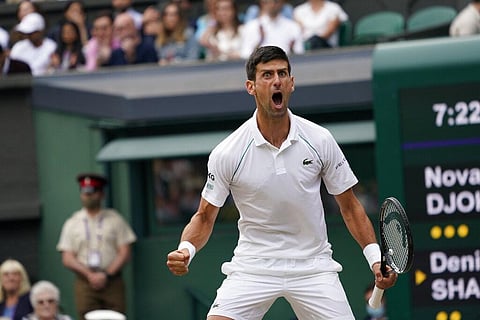 Serbia's Novak Djokovic celebrates after winning a point against Canada's Denis Shapovalov during the men's singles semifinals match on day eleven of the Wimbledon. (Photo | AP)