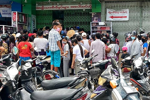 eople wait outside a shop where face masks and vitamins are being given away in Mandalay, Myanmar, Thursday, July 8, 2021. (Photo | AP)