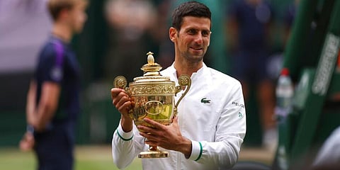 Novak Djokovic holds his winner's trophy and celebrates his victory over Matteo Berrettini during the men's singles final of the Wimbledon Tennis Championships in London. (Photo | AP)