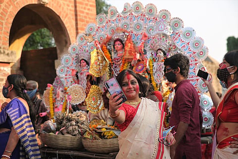 No matter what, a selfie with the Durga Idol is a must to keep up with the festive fever and the social circle abuzz. (Photo | Sunish P Surendran)