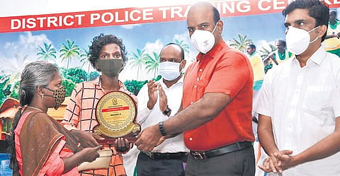 Mridul K, accompanied by his mother, receives a memento from the police after clearing the SSLC exam on his second attempt | EXPRESS