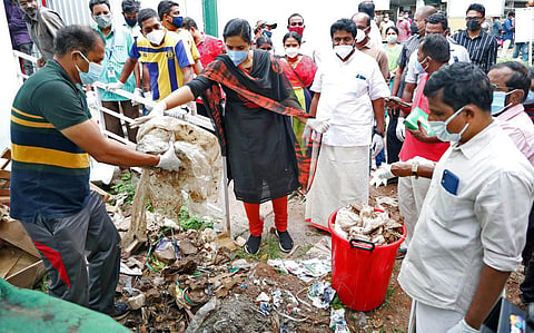 Mayor Arya Rajendran gives trash to the treatment facility inaugurated at the  corporation office. (Photo | EPS)