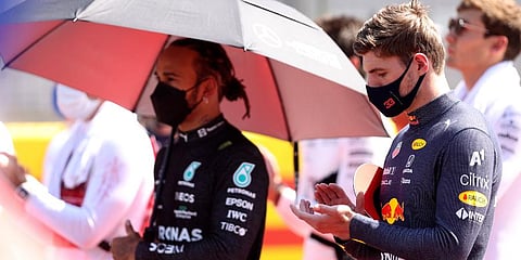 Red Bull driver Max Verstappen (R) and Mercedes driver Lewis Hamilton stand on the grid before the start of the British Formula One Grand Prix, at the Silverstone circuit. (Photo | AP)