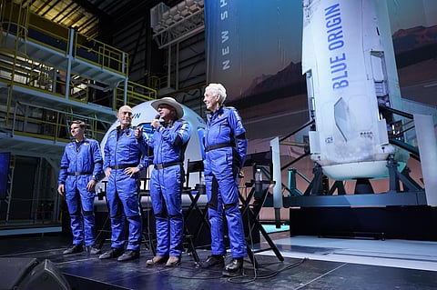 Oliver Daemen, from left, Mark Bezos, and Wally Funk, right, listen as Jeff Bezos  makes comments after their flight experience. (Photo | AP)