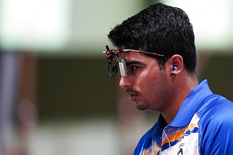 Saurabh Chaudhary of India, pauses as he competes in the men's 10-meter air pistol at the Asaka Shooting Range in the 2020 Summer Olympics. (Photo | AP)