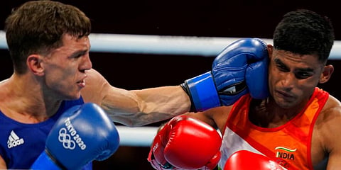 India's Manish Kaushik (R) exchanges punches with Britain's Luke McCormack during their men's lightweight 63-kg boxing match at the 2020 Summer Olympics in Tokyo, Japan. (Photo | AP)