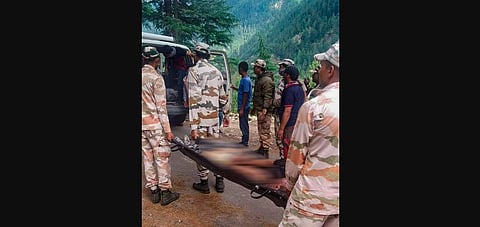 ITBP personnel carry an injured after a landslide at Batseri of Sangla valley in Kinnaur district. (Photo | PTI)