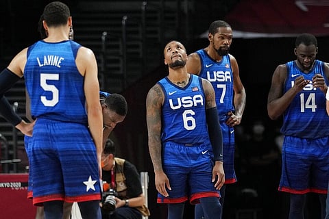 United States' Damian Lillard (6), Kevin Durant (7), and Draymond Green (16) their loss to France in wait for play to resume during their loss to France. (Photo | AP)