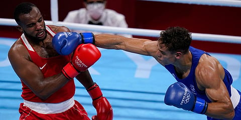 New Zealand's David Nyika (R) lands a punch to Youness Baalla, of Morocco, during their heavy weight (91kg) preliminary boxing match at the 2020 Summer Olympics in Tokyo, Japan. (Photo | AP)