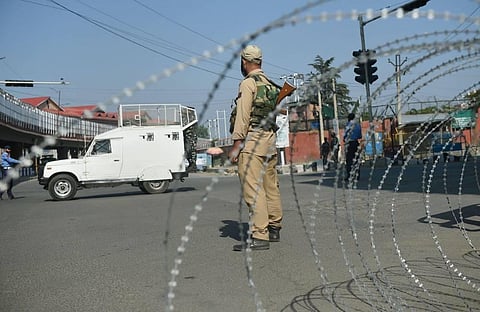 Security personnel stand guard on a street during restrictions imposed in the wake of the first anniversary of Article 370 abrogation in Srinagar. (File Photo | PTI)