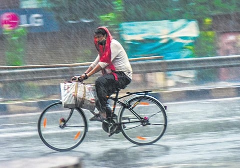 A cyclist braves heavy rainfall 