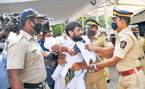 BJP legislator Ram Satpute is taken away by policemen during the stormy opening day of  Maharashtra Assembly, in Mumbai. (Photo | PTI)