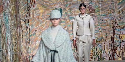 The Dior 2021-22 Haute Couture show opened with a range of black-and-white checks and tweeds with matching boots — some looks embroidered with feathers for a tweed effect. (Photo | AP)