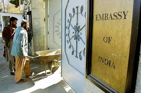 An Afghan labourer pushes a wheelbarrow into the Indian embassy in Kabul. (File Photo | AFP)