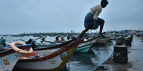 (For representational purposes) A fisherman jumps off the fishing boat. (Photo | P Jawahar, EPS)