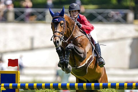 Jessica Springsteen of the United States, on Don Juan Van de Donkhoeve, clears an obstacle during the Nations Cup horse jumping competition. (Photo | AP)