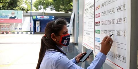 A pump attendant writes the current increased prices at a fuel station. (Photo | Shekhar Yadav, EPS)