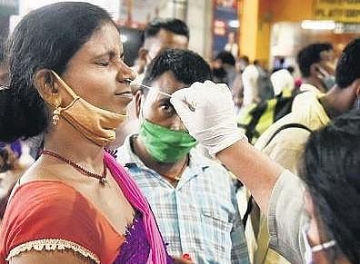 A healthcare worker collects swab sample from a woman for Covid testing  in New Delhi. (File Photo | Parveen Negi, EPS)