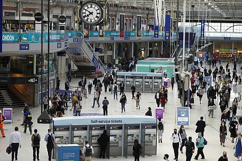 People wear face masks to curb the spread of coronavirus during the morning rush hour at the commuter hub, Waterloo train station in London. (Photo | AP)