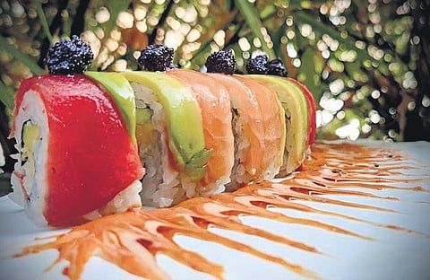 Sushi is served with soy sauce, wasabi sauce and pickled ginger.