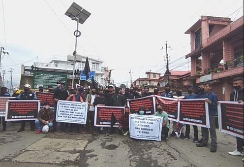Hundreds of people, wearing black and carrying blag flags, took part in his funeral procession.