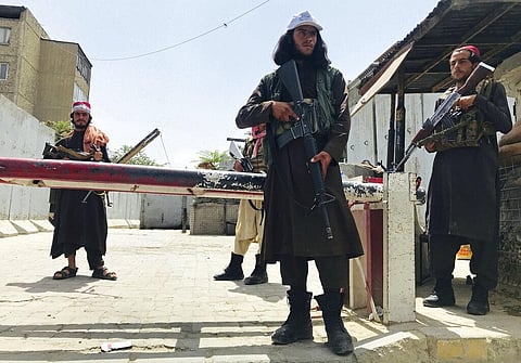 Taliban fighters stand guard at a checkpoint near the US embassy that was previously manned by American troops, in Kabul, Afghanistan. (Photo | AP)