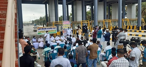 Congress workers stage a sit-in at the toll plaza in protest against the toll collection from Wednesday without opening up the entire 43-km stretch