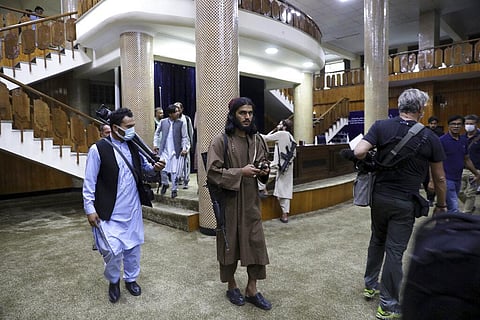 Taliban fighters stand guard before the Taliban spokesman Zabihullah Mujahid arrives for his first news conference. (Photo | AP)