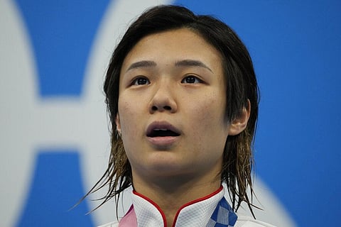 Shi Tingmao of China pose for a photo after winning gold medal in women's diving 3m springboard final at the Tokyo Aquatics Centre at the 2020 Summer Olympics. (Photo | AP)