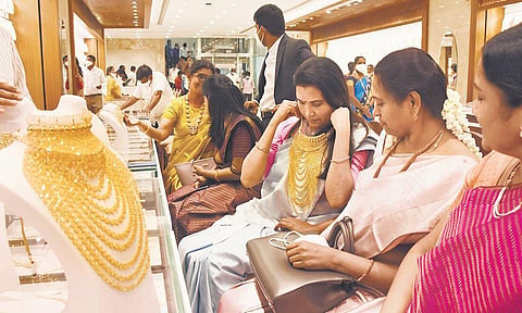 Customers try out jewellery at the newly-opened Pothys Swarna Mahal at Chromepet in Chennai on Friday | ashwin prasath