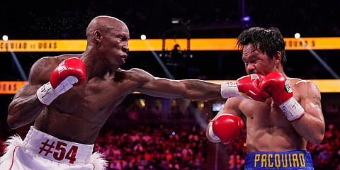 Yordenis Ugas, of Cuba, hits Manny Pacquiao, of the Philippines, in a welterweight championship boxing match in Las Vegas. (Photo | AP)