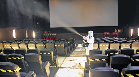 A day ahead of reopening, a theatre in Chennai being sanitised on Sunday. (Photo | EPS/Ashwin Prasath)