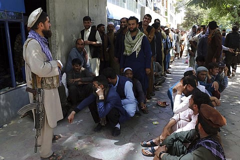 Afghans wait in front of Kabul Bank, in Kabul, Afghanistan, Wednesday, Aug. 25. 2021. (Photo | AP)