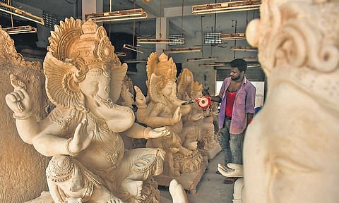 An artisan works on idols of Lord Ganesha made last year at his workshop. (Photo I Prasant Madugula, EPS)