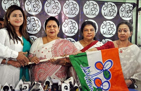 Lok Sabha MP Mala Roy (2nd L) and party MLA Nayna Bandopadhyay (L) hand over party flag to Congress leaders Shikha Mitra (2nd R) and Shuvra Ghosh (R) after they joined TMC. (Photo | PTI)