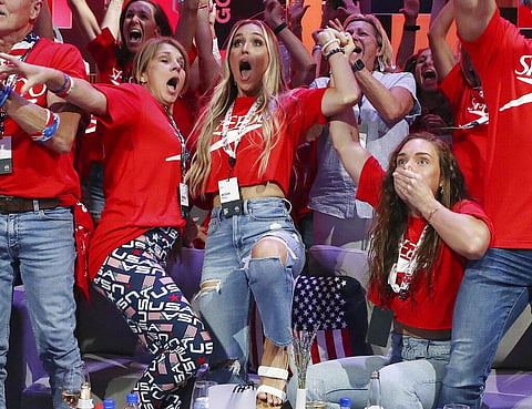 Christina Dressel, left, mother of Caeleb Dressel, and Meghan Dressel, his wife, both fall down Friday, July 30, 2021, in Orlando. (Photo | AP)