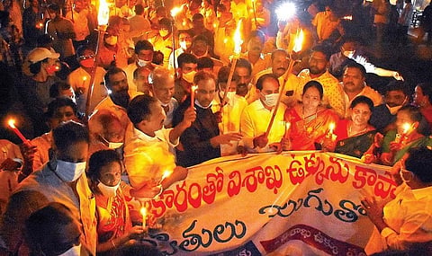 Torch light rally being taken out by Visakha Ukku Parirakshana Porata Committee in Vizag on Monday. (Photo | EPS/G Satyanarayana)