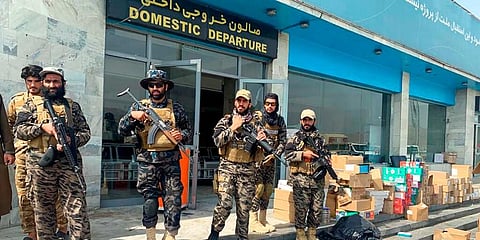 Taliban fighters stand guard inside the Hamid Karzai International Airport after the US withdrawal in Kabul. (Photo | AP)