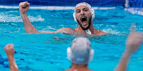 Greece's Konstantinos Genidounias, top, celebrates after scoring a goal against Montenegro during a quarterfinal round men's water polo match at the 2020 Olympics, in Tokyo, Japan. (Photo | AP)