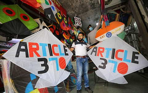 A vendor shows specially designed kites on the second anniversary of abrogation of article 370 and bifurcation of J&K into two UTs, in Jammu, Thursday, Aug. 5, 2021. 