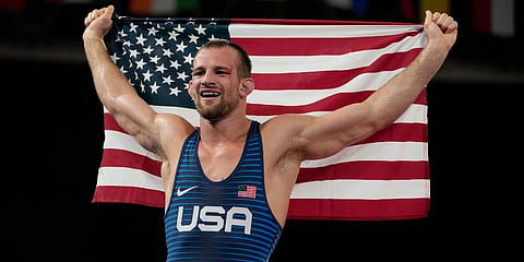 United States' David Morris Taylor III celebrates holding the US flag after winning the gold medal in the men's 86kg Freestyle wrestling event at the 2020 Olympics in Tokyo, Japan. (Photo | AP)