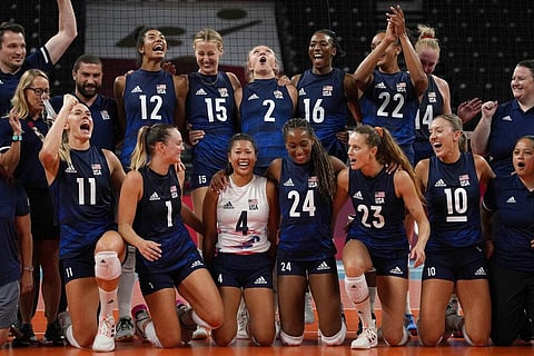 United States players pose for a photo to celebrate winning the women's volleyball quarterfinal match between Dominican Republic and United States. (Photo | AP)