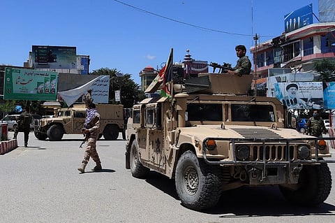 Afghan security forces sit in a Humvee vehicle amid ongoing fighting between Taliban militants and Afghan security forces in Kunduz on May 19, 2020. (Photo | AFP)